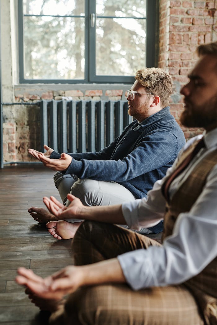 Two men practicing meditation indoors, embodying mindfulness and tranquility.